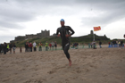 Start of the second lap in the simming during the Bamburgh Triathlon with Bamburgh Castle in the background